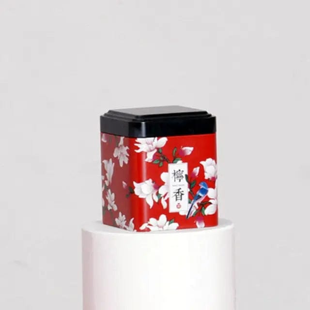 Rode metalen theedoos met witte bloemen